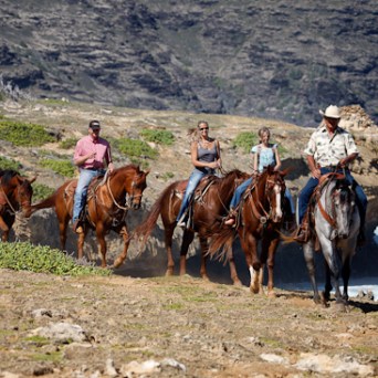 a group of people riding on the back of a horse