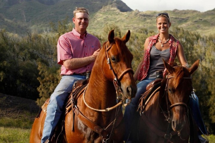a man riding a horse in front of a mountain