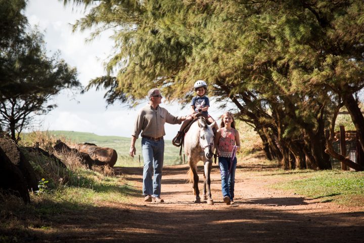 a man riding a bike down a dirt road